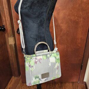 Bebe crossbody green and white stripe with silver tone handles, Zip close top.